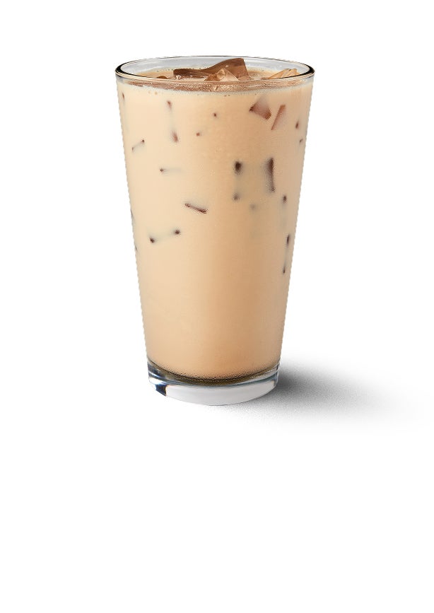 An iced chai tea latte in a tall glass