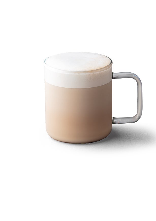 A chai tea latte in a glass mug