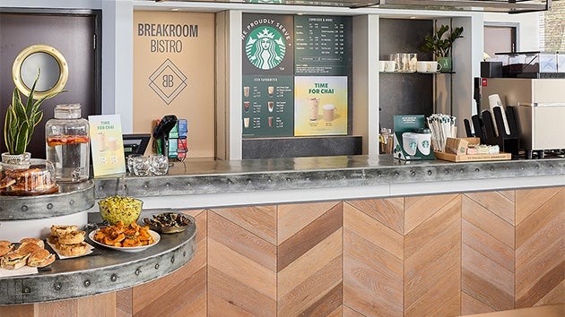 A We Proudly Serve Starbucks serving counter