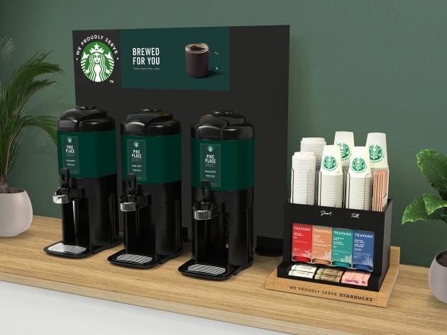 The brewed solution in tall, featuring a self-service coffee station with three large coffee dispensers and a tea selection