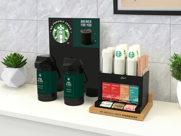 The brewed solution in short, featuring a self-service coffee station with two large coffee dispensers and a tea selection