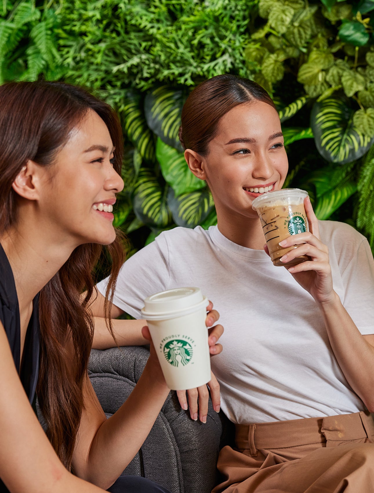 Colleagues sitting together with We Proudly Serve Starbucks cups