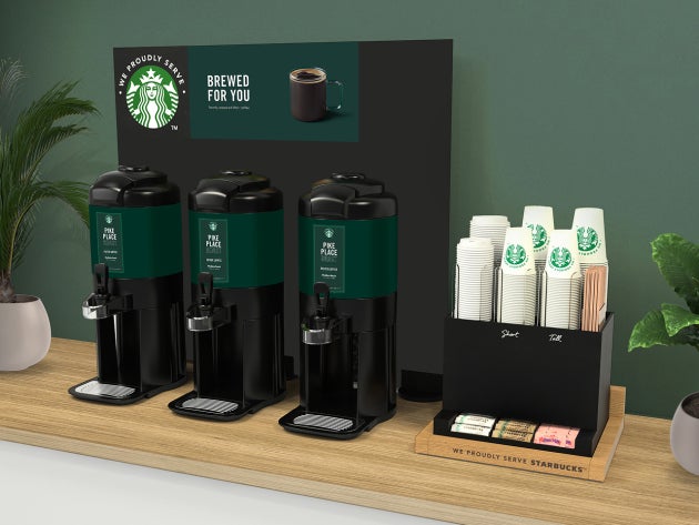 The brewed solution in tall, featuring a self-service coffee station with three large coffee dispensers and a tea selection
