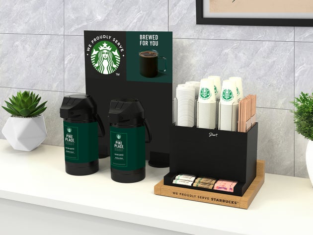 The brewed solution in short, featuring a self-service coffee station with two large coffee dispensers and a tea selection